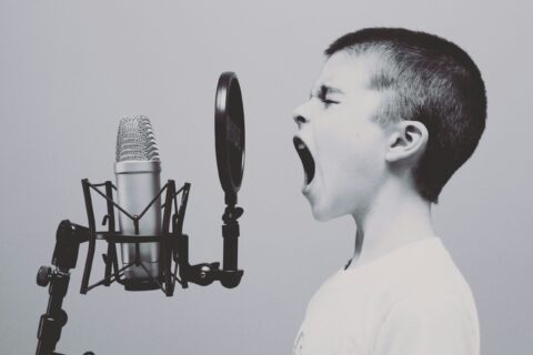 Young child shouting into microphone