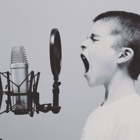 Young child shouting into microphone